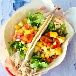 Two chicken tacos in a basket.