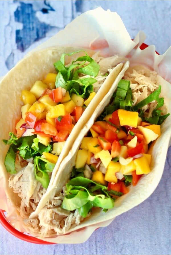 Two chicken tacos in a basket.