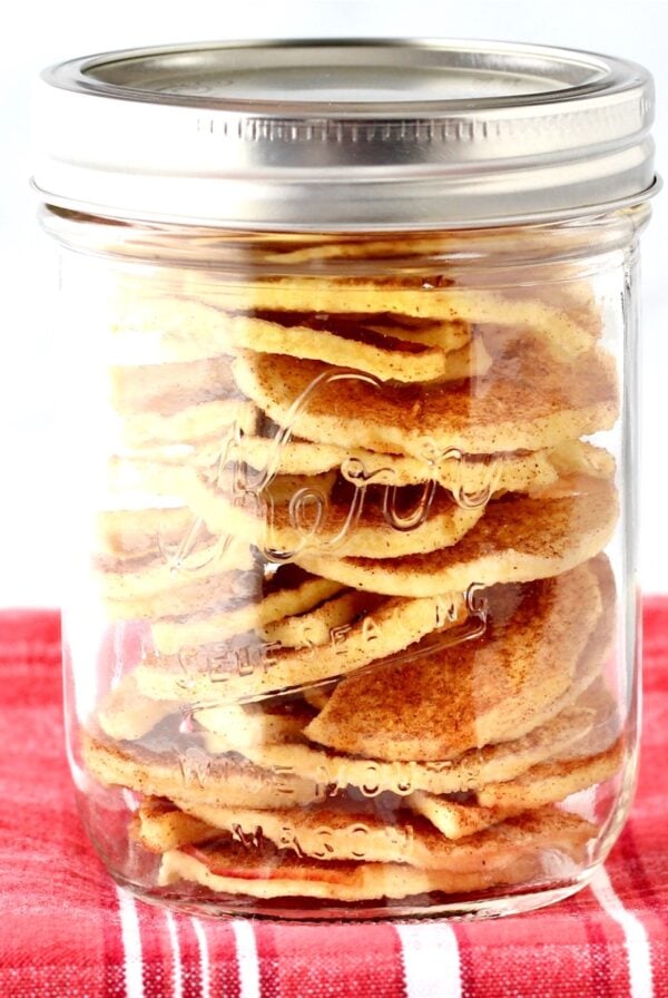 Apple chips stacked in a mason jar.