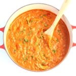 Lasagna soup in Dutch Oven with a wooden spoon.