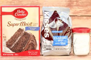 Containers of chocolate fudge cake mix, Hershey kisses, and powdered sugar.