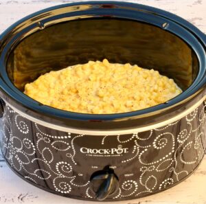 Cooked cream corn with cream cheese in slow cooker.