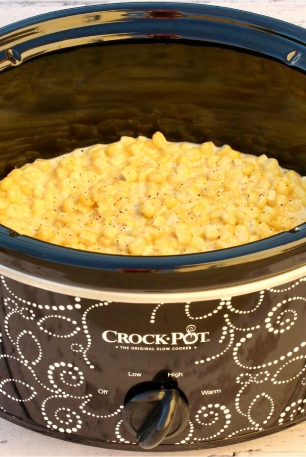 Cooked cream corn with cream cheese in slow cooker.