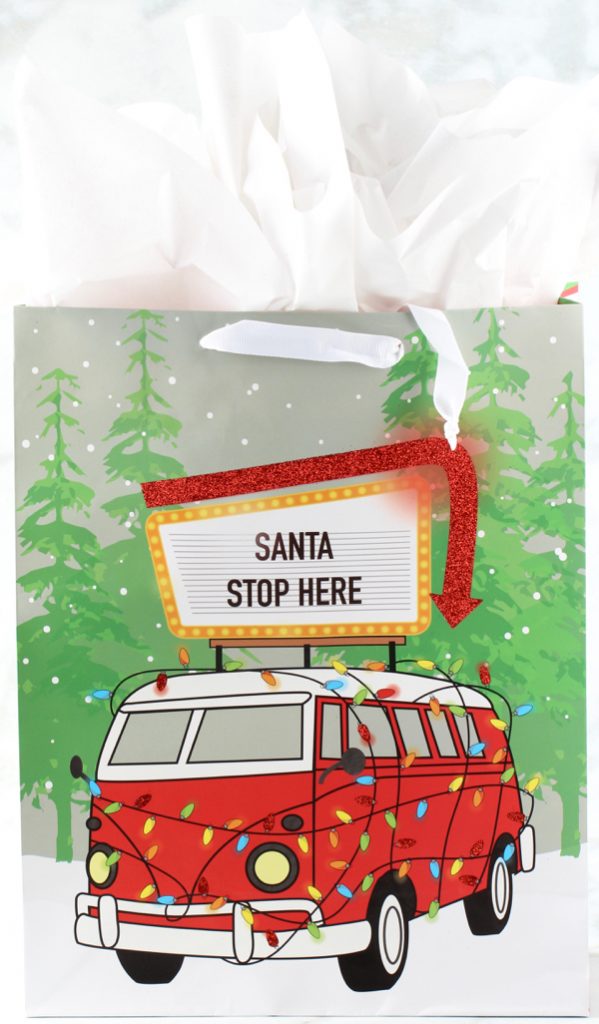 Christmas gift bag labeled \"Santa Stop Here.\"