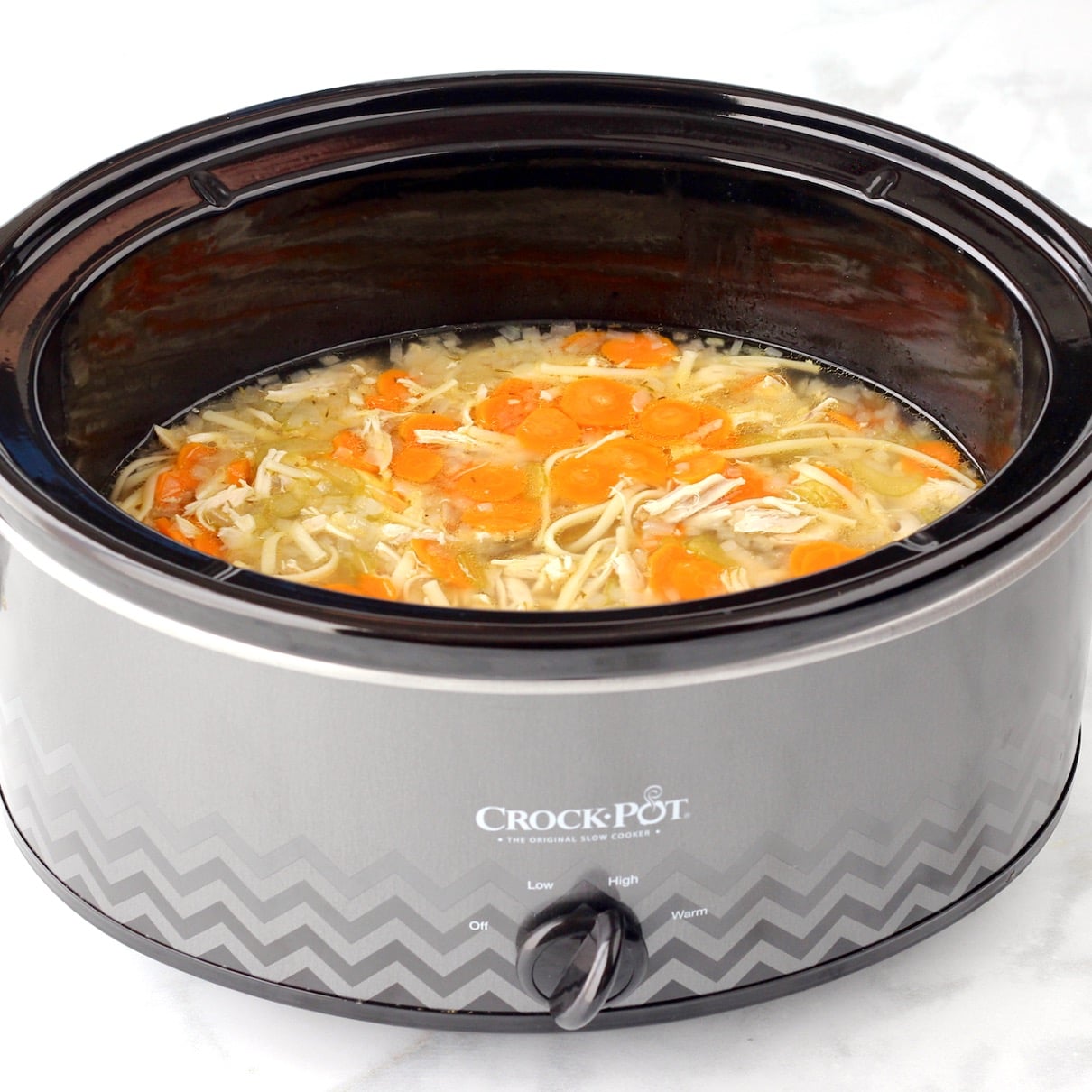 Grey Crockpot of Chicken Noodle Soup.