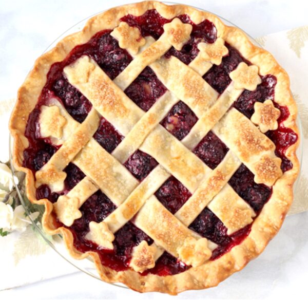 Blackberry Pie in a glass pie dish with a lattice top.
