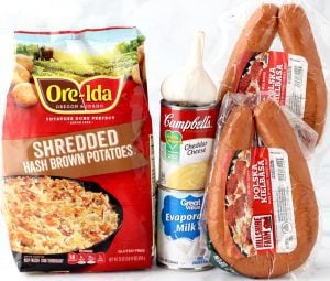 Sausage and potato casserole ingredients including evaporated milk, garlic, and kielbasa.
