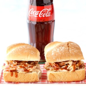 Barbecue chicken sandwiches with a bottle of Coke.