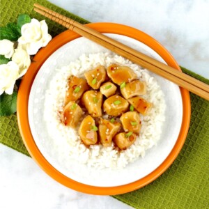Plate of orange chicken on rice.