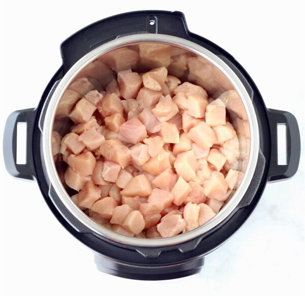 Cubes of chicken in an Instant Pot.