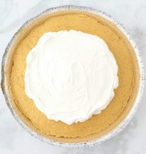 Cool Whip over pumpkin mixture in a pie crust.