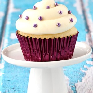 Cupcake topped with cream cheese frosting.