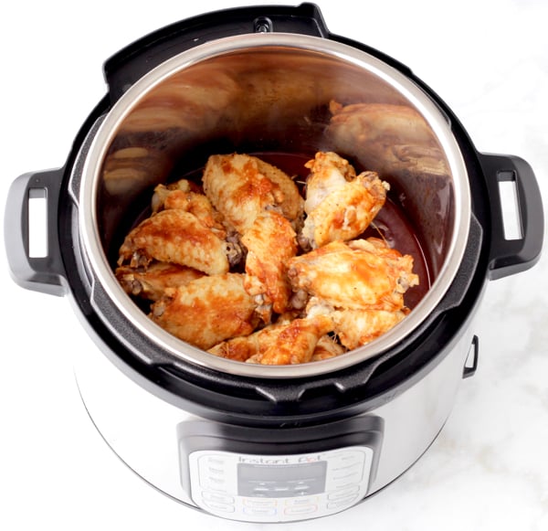 Chicken wings in Instant Pot with barbecue sauce.