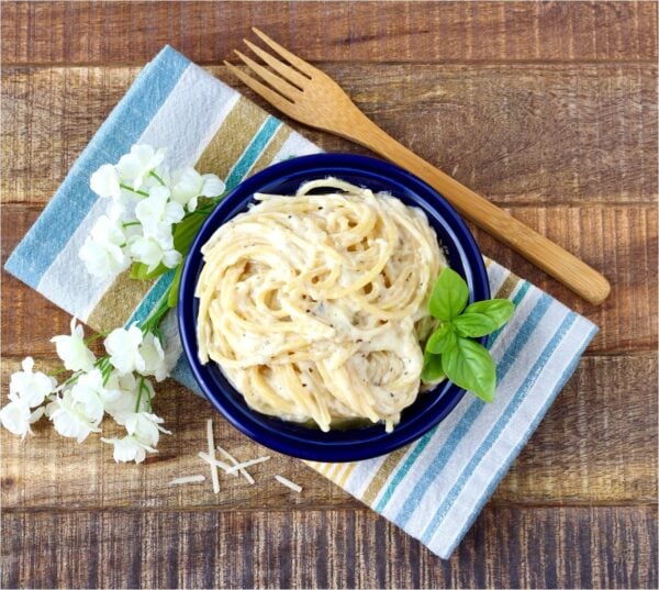 Garlic Parmesan Pasta in small dish with napkin underneath and a fork to the side.