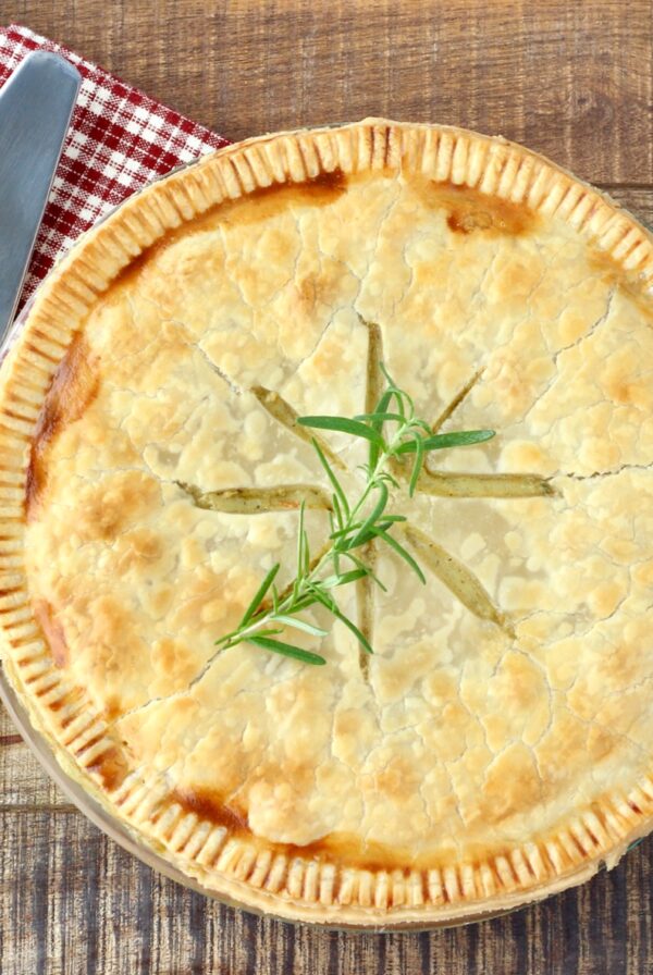 Double crust chicken pot pie with pie server.