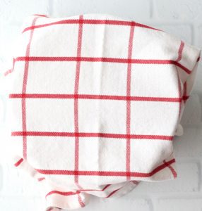 Red and white towel draped over a bowl.