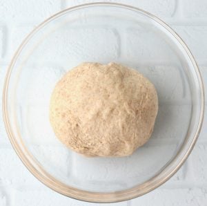 Glass bowl of bread dough.