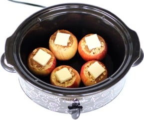 Apples with butter and filling in a slow cooker.
