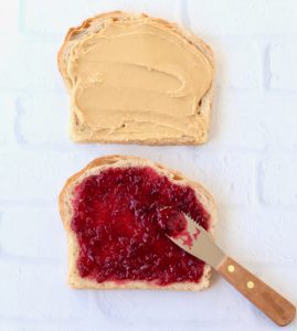 Peanut butter and jelly spread on two slices of bread.