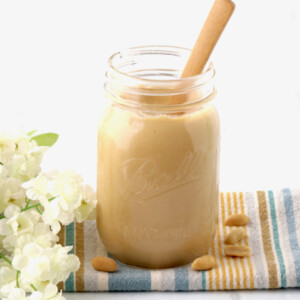Wooden spoon in a jar of peanut butter.