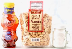 Containers of peanuts, honey, and salt.