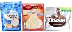 Containers of coconut flakes, French vanilla cake mix, and Hershey's kisses.
