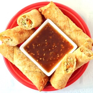 Egg rolls with a bowl of Ginger Soy Sauce.
