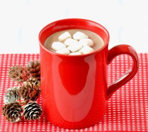 Hot chocolate in a red mug with marshmallows.
