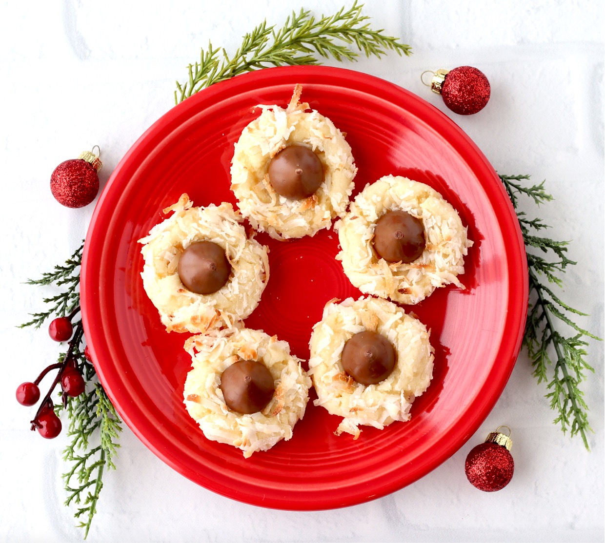 Hershey Kiss cookies with coconut on plate.