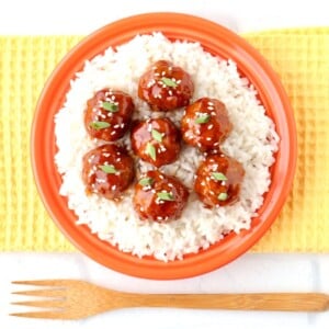 Plate of Orange Meatballs over rice.