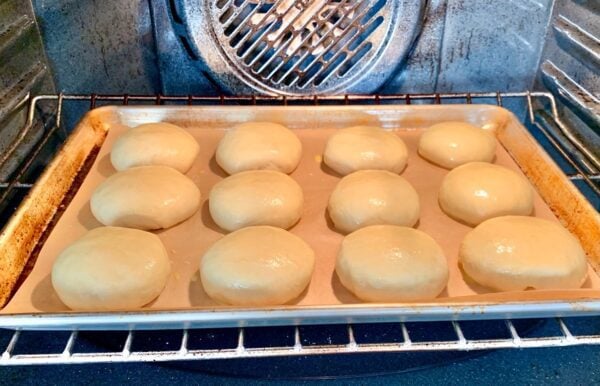 Baking sheet of dough in an oven.