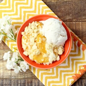 Peaches and Cream Cobbler in a red bowl.