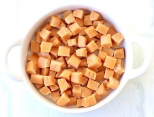 Caramels in a white dish.