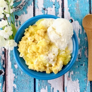 Blue bowl of lemon cream cheese dump cake.