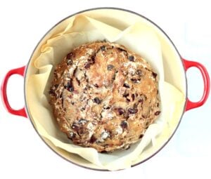 Loaf of cranberry walnut bread in a Dutch oven.
