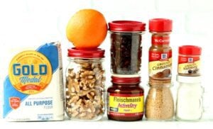 Cranberry walnut bread ingredients including yeast, cinnamon, and an orange.