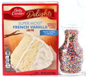 Box of French vanilla cake mix and a container of sprinkles.