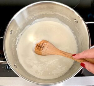Person stirring melted marshmallow mix.