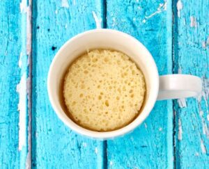 White mug filled with lemon cake.
