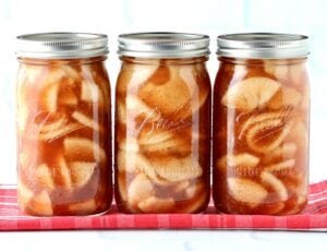 Several covered jars of apple pie filling.