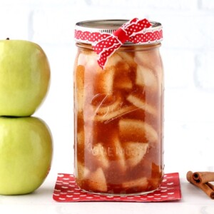 Jar of apple pie filling tied with a ribbon.