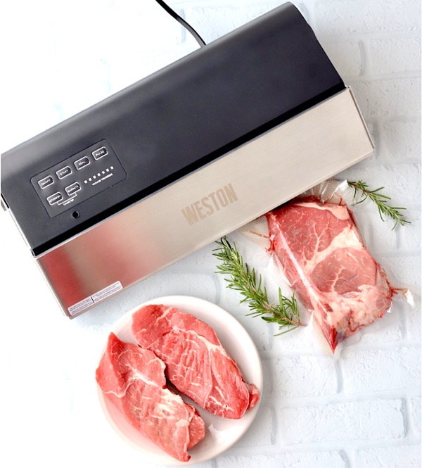 Steak being vacuum sealed in bag.