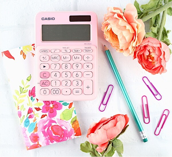 Calculator, paper clips, a pencil, and flowers.