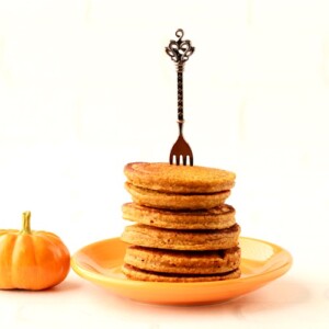 Fork in a stack of pumpkin oatmeal pancakes.