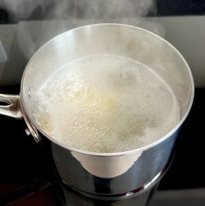 Noodles in a pot of boiling water.