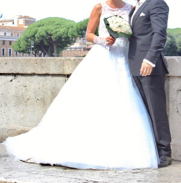Bride and groom on sidewalk.