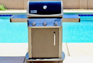 Grill next to a pool.