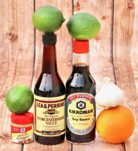 Steak Marinade ingredients including soy sauce, limes, and ground ginger.