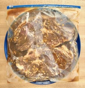 Bag of marinating steaks.