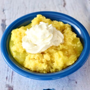 Lemon Dump Cake topped with whipped cream.